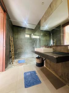 a bathroom with a sink and a large mirror at The balangan studio room 7 in Bingin Beach