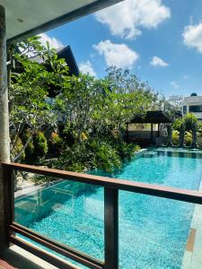 a view of a swimming pool from a balcony at The balangan studio room 7 in Bingin Beach +4 photos