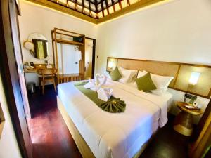 a bedroom with a large bed with a flower on it at PARAWIYA Villa in Munduk