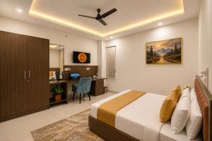 a bedroom with a bed and a desk with a computer at Hotel The Heights in Haridwār +21 photos