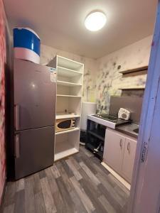 an empty kitchen with a refrigerator and a counter at Maison Velours - LIMITLESS in Champigny-sur-Marne