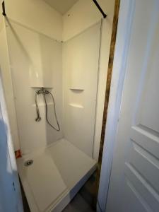 a white walk in shower in a room at Maison Velours - LIMITLESS in Champigny-sur-Marne