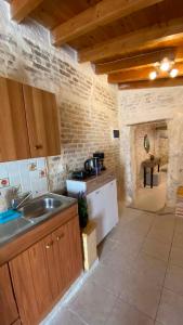 a kitchen with a sink and a counter top at CASA THEOTOKI in Anemómylos