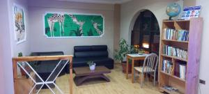 a living room with a couch and a chair and a table at Colonia Real in Sucre