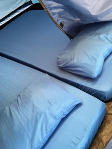 two beds are sitting next to each other at Redang Campstay in Redang Island