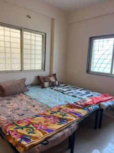 a large bed in the corner of a room at Suyakshi homestay in Pune +31 photos