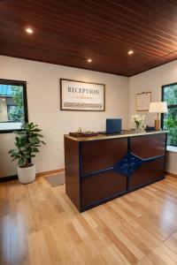 an office with a reception desk with a laptop on it at Misty D Silver in Munnar