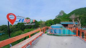 a bridge with a sign next to a mountain at PhaluaiHomestay พะลวยโฮมสเตย์ บ้านไม้ in Koh Phaluai +50 photos