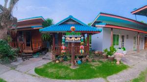 a small house with a sign in front of it at PhaluaiHomestay พะลวยโฮมสเตย์ บ้านไม้ in Koh Phaluai