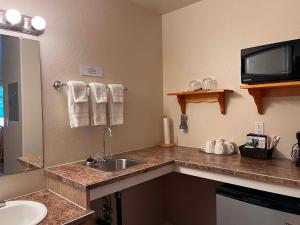a bathroom with a sink and a counter top at Denali Fireside Cabin & Suites in Talkeetna +47 photos