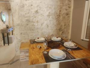 a dining table with plates and glasses on it at CASA THEOTOKI in Anemómylos +111 photos