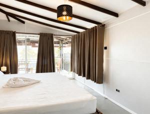 a bedroom with a white bed and a window at Kumarana in Bentota +13 photos