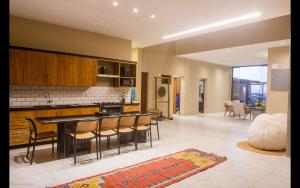 a kitchen with a table and chairs in a room at Dona Chica Wellness Center in Taíba