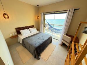 a bedroom with a bed and a view of the ocean at Dona Chica Wellness Center in Taíba +42 photos