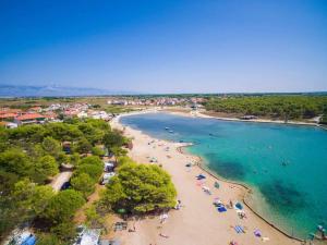 an aerial view of a beach with people in the water at Mobilehome Lana in Privlaka