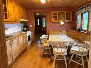 a kitchen with a table and chairs in a room at Skjevlingsnes sjøhus in Tingvoll