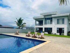 a house with a swimming pool in front of a house at Bountiful Estates Fantasy in Nadi