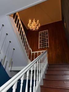 a staircase with a chandelier in a house at Imperial in Tamengos +2 photos