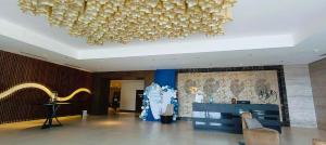 a lobby with a large chandelier in a building at Mactan Newtown Condo Rental in Punta Engaño +47 photos