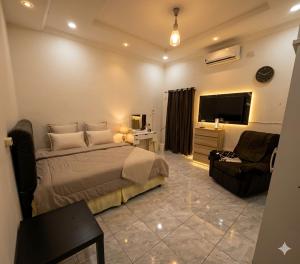 a bedroom with a bed and a tv and a couch at Lamar home in Jakarta
