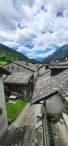 an overhead view of roofs of buildings with mountains at Casa Silvia in Promontogno