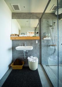 a bathroom with a sink and a shower at TUZUMI Wakayama Susami in Esumi +7 photos