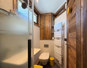 a small bathroom with a toilet and a shower at Homency - Résidence Ménandière V2 spot in L'Alpe-d'Huez +24 photos