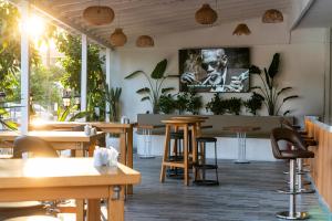 a restaurant with wooden tables and chairs and plants at Aurasia Sea Side Hotel in Marmaris