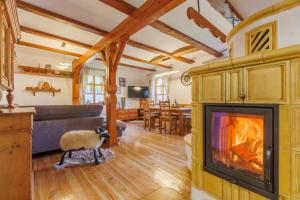 a living room with a fireplace and a couch at Chalupa Vysoký Potok in Malá Morava
