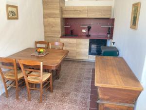 a kitchen with a wooden dining table and chairs at Quiet, fresh, and nice in Letia