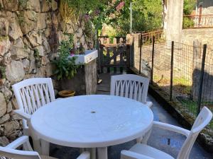a white table and chairs on a patio at Quiet, fresh, and nice in Letia +2 photos