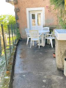 a patio with a table and chairs in front of a building at Quiet, fresh, and nice in Letia
