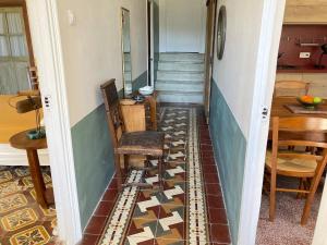 a hallway with a stairway with chairs and a table at Quiet, fresh, and nice in Letia