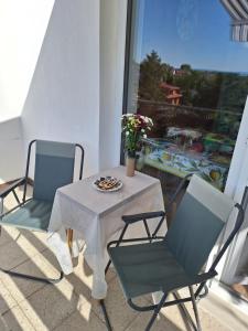 two chairs and a table on a balcony at Privat Tatry Dreams in Nová Lesná