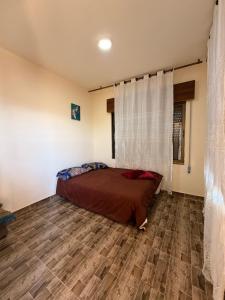 a bedroom with a bed and a wooden floor at Luxury Mountain Chalet with Private Pool Lionden Jerash in Jerash