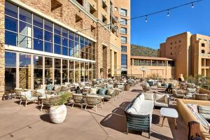 a patio with chairs and tables in front of a building at JW Marriott Tucson Starr Pass Resort in Tucson
