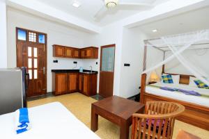 a living room with a bunk bed and a table at Soulinn Regina Weligama in Weligama