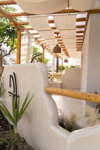 a white couch sitting in a room with a table at MaDaM Essence in Nei Poroi +41 photos