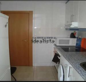 a kitchen with a door and a counter top at Casa Lago in Zaragoza +10 photos