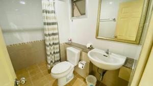a bathroom with a toilet and a sink at City Hill Residence in Ban Khok Chang +9 photos