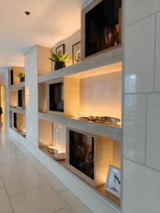 a room with a wall filled with shelves at MOA shell residences - JOSH in Manila
