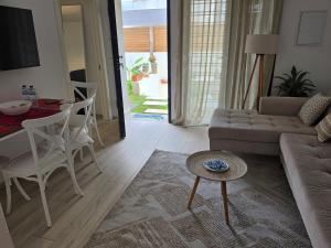 a living room with a couch and a table at Mon jardin secret in La Marsa