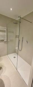 a bathroom with a glass shower with a toilet at Hotel Serafino in Padova