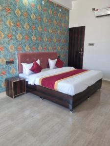 a bedroom with a large bed with red pillows at Veer Guest House in Bareilly +25 photos
