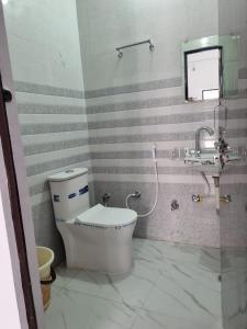 a bathroom with a toilet and a sink at Veer Guest House in Bareilly