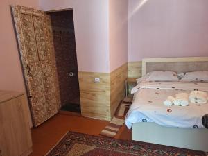 a bedroom with a bed and a shower and a door at Davti Toon Guesthouse in Aghitu