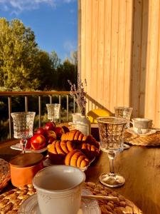 a table with a plate of food and wine glasses at Marjan bay in Tossor