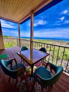 a table and chairs on a deck with a view of the ocean at Marjan bay in Tossor