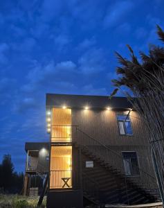 a house with lights on the side of it at Marjan bay in Tossor +28 photos