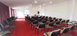 a room with a bunch of chairs and a podium at Delta Palace in Sulina